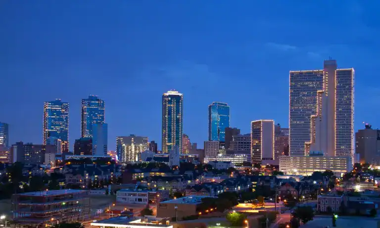 The downtown Fort Worth skyline at dusk under a deep blue sky